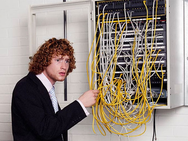 Man looking confused holding wires