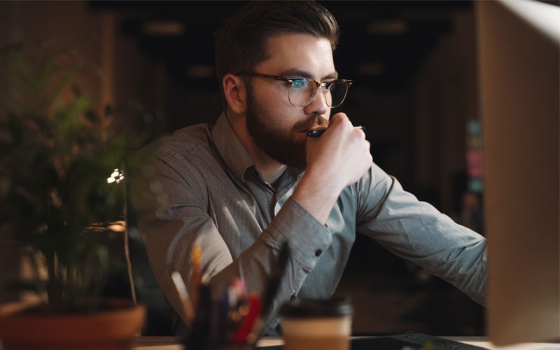 Hybrid cloud management platform Male working at desk at night